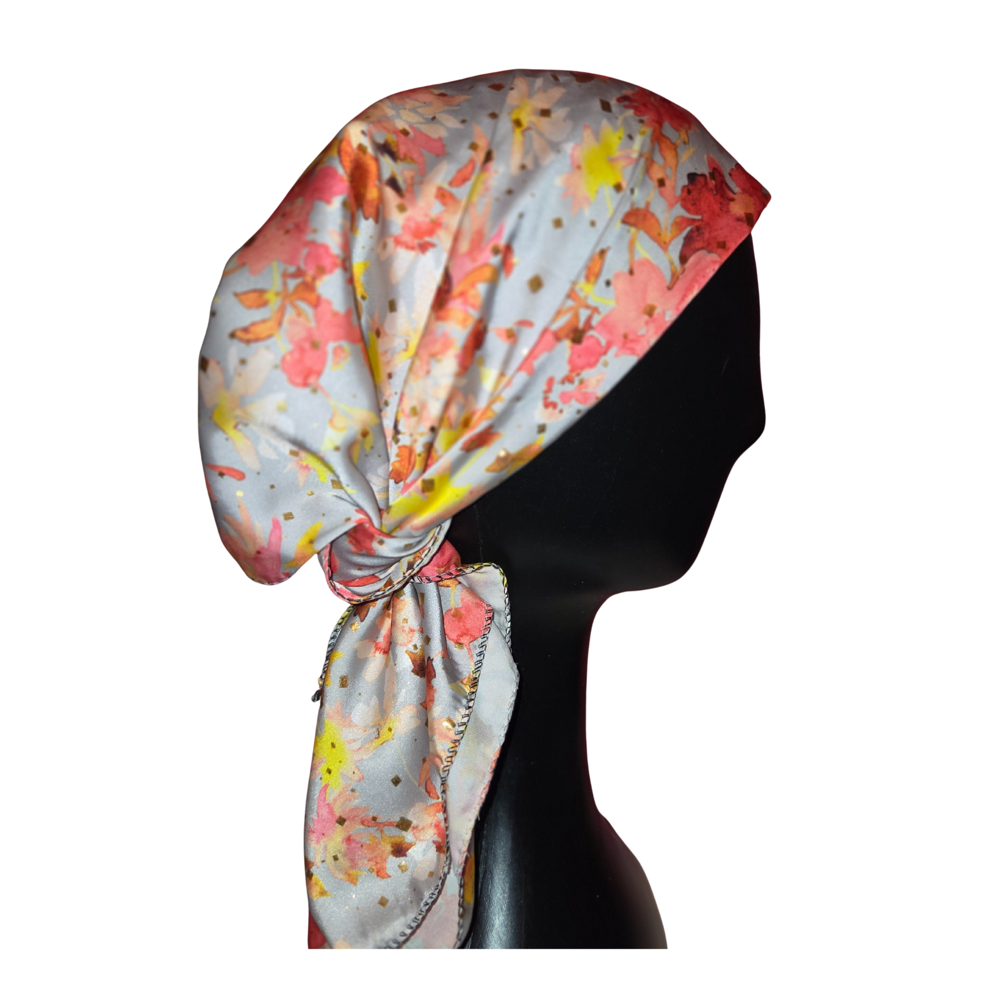 Colorful headscarf with floral pattern on a mannequin head against a white background