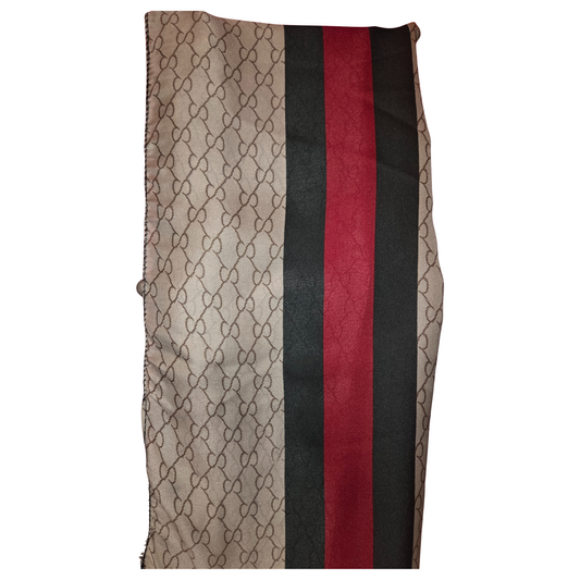 Striped fabric with geometric pattern and red, black, and beige colors on a white background
