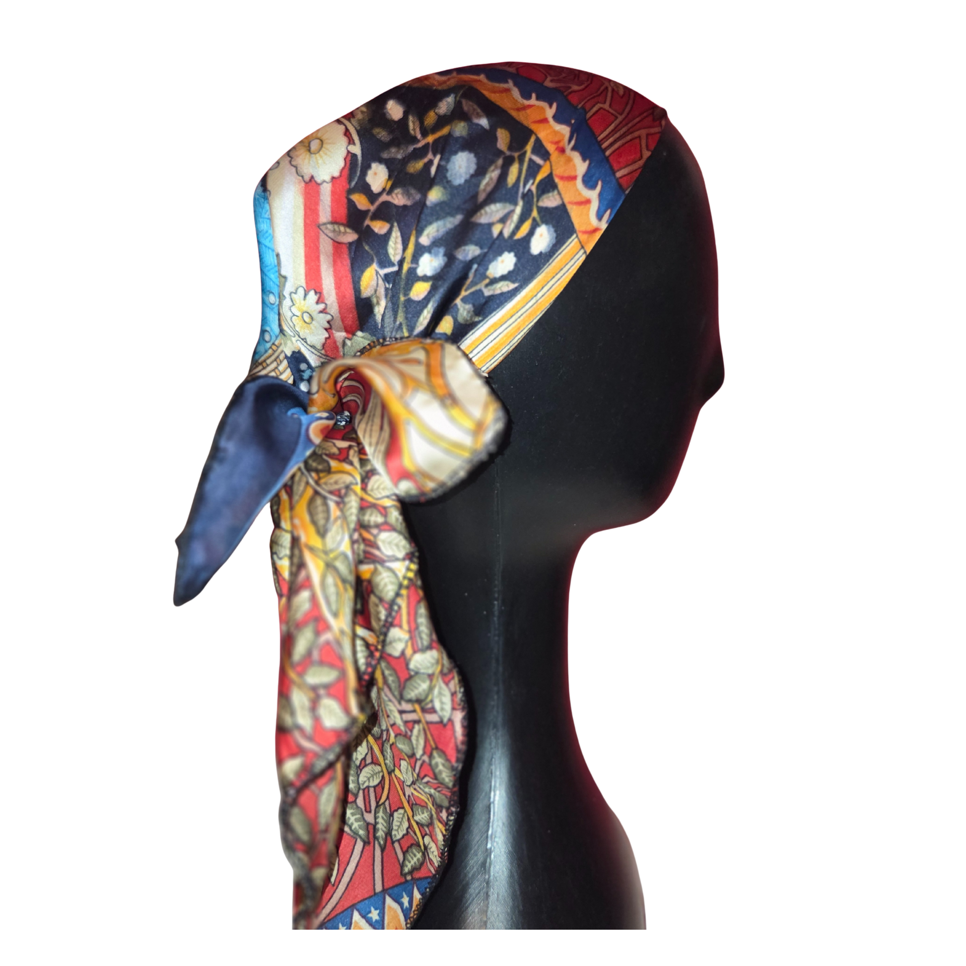 Colorful patterned headscarf on a mannequin head against a white background