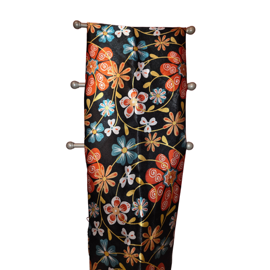 Decorative headboard with floral pattern on a black background