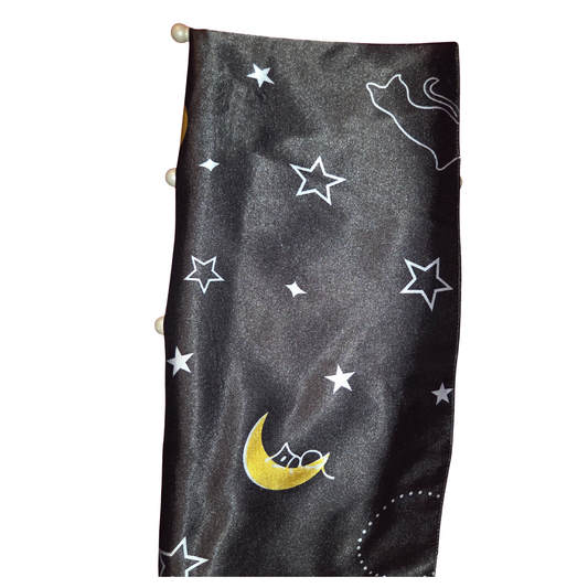 Black fabric with white star patterns and a yellow moon on a white background