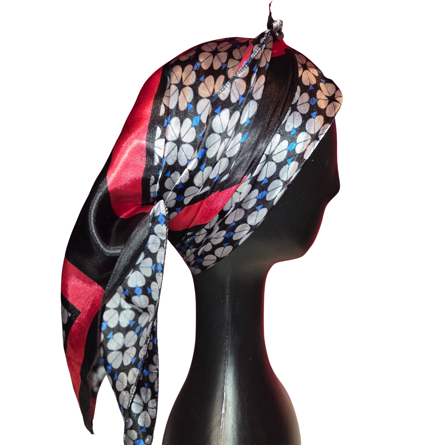 Colorful floral headscarf on a mannequin head against a white background