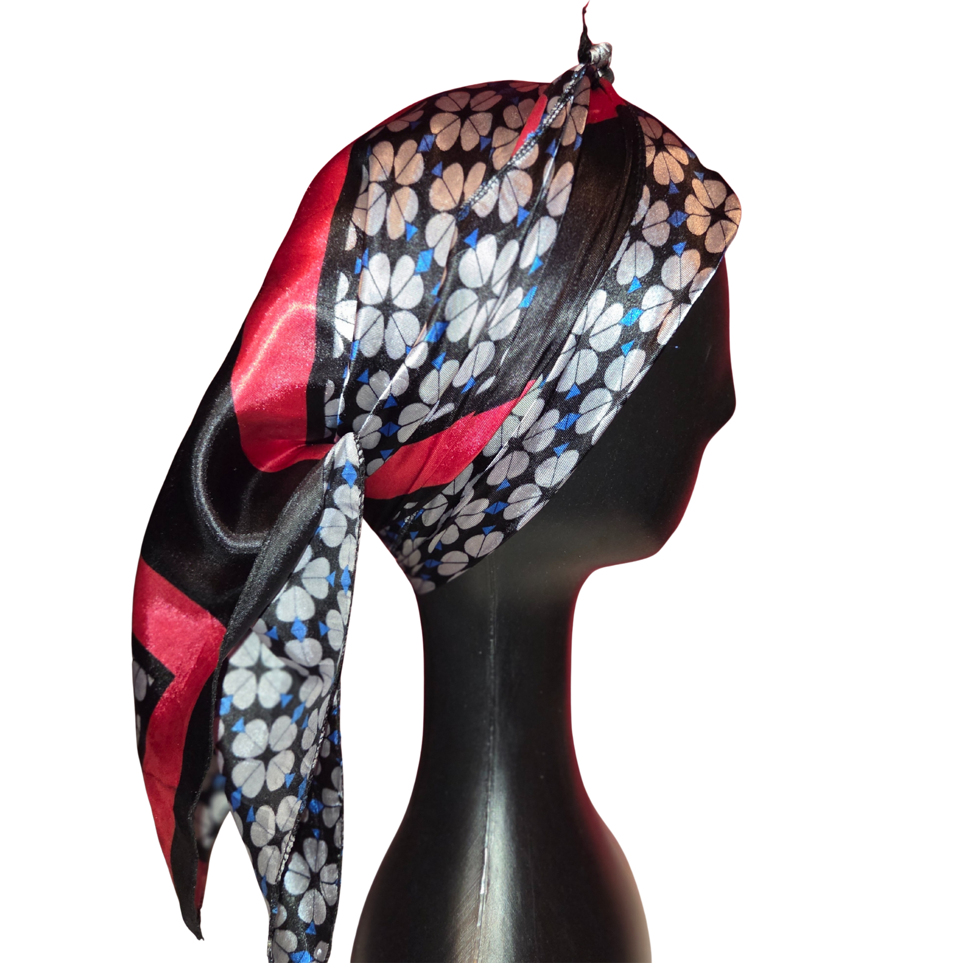 Colorful floral headscarf on a mannequin head against a white background