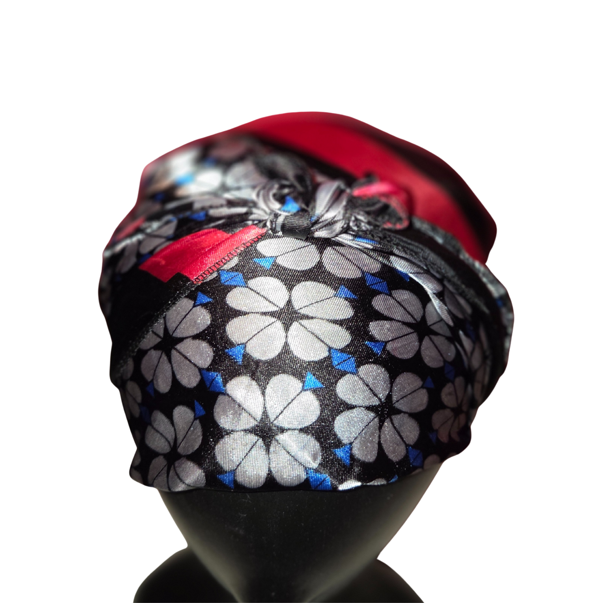 Floral patterned headscarf on a mannequin head with a red top