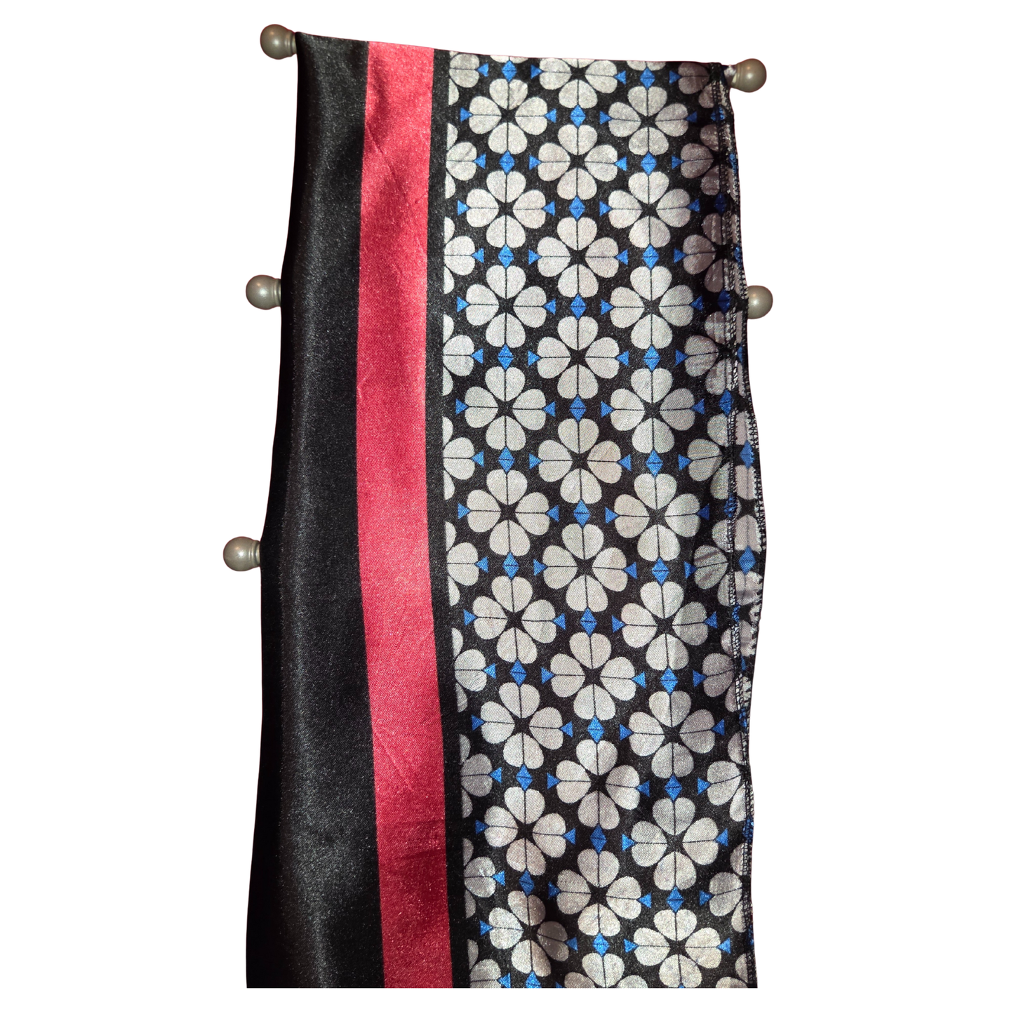 Scarf with black, red, and floral pattern on a white background