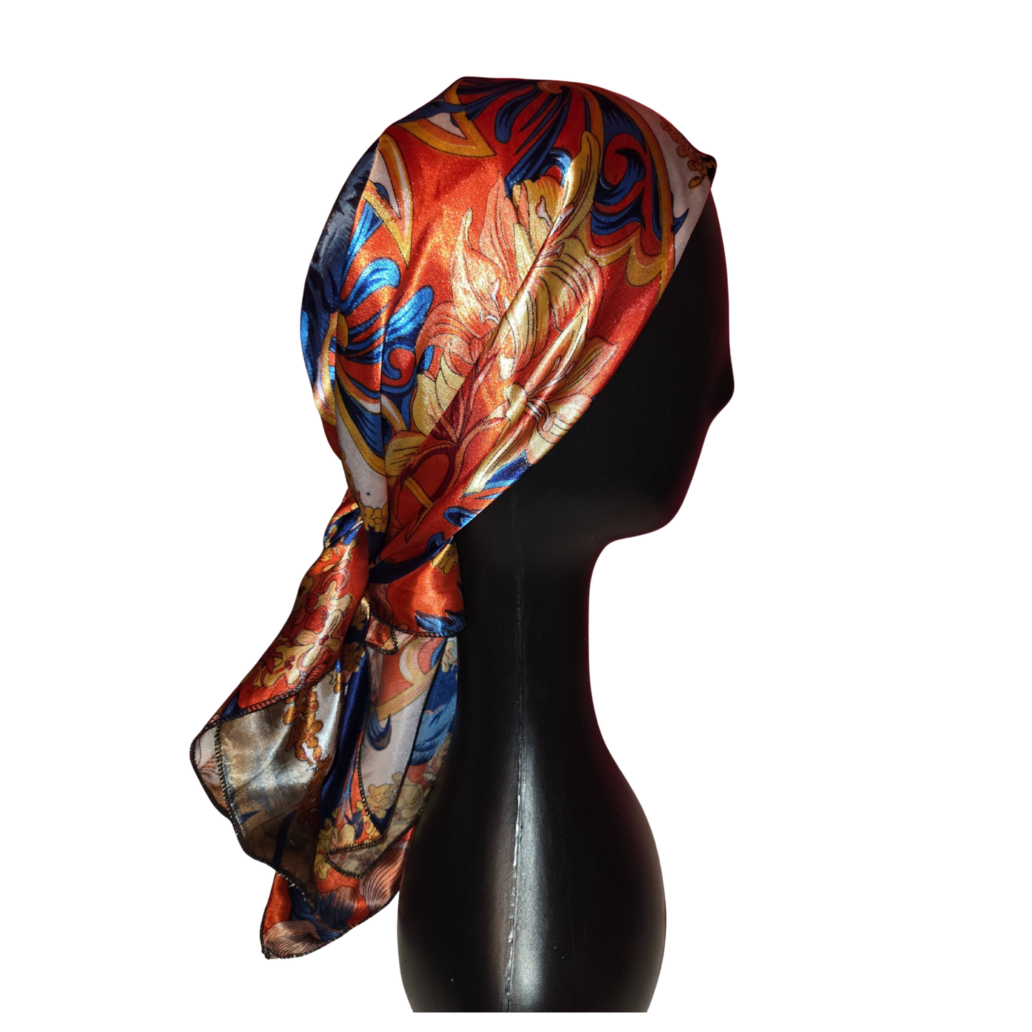 Colorful headscarf on a black mannequin head against a white background