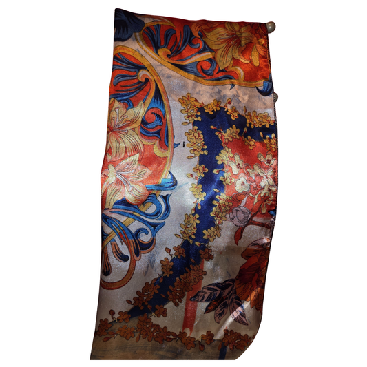 Decorative scarf with floral and paisley patterns on a white background