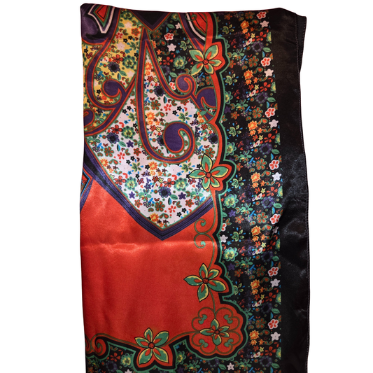 Colorful patterned fabric with floral and paisley designs on a white background