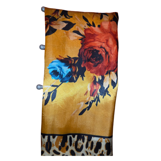 Floral patterned fabric with leopard print border on a yellow background