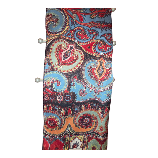 Colorful paisley patterned fabric roll on a white background