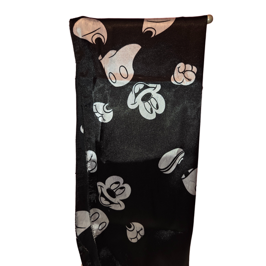 Black towel with white cartoon character faces on a white background